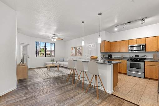 A kitchen with a dining table and chairs in the middle of the room.
