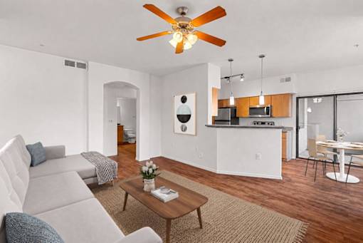 A living room with a grey couch and a wooden coffee table.
