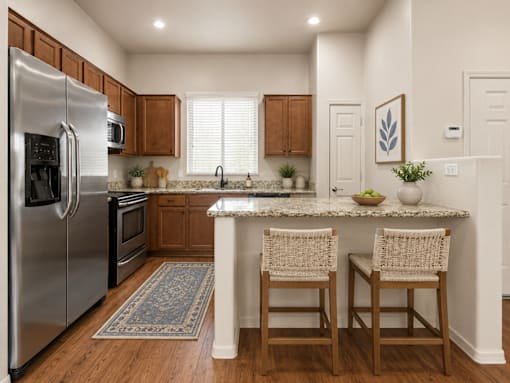 A kitchen with a refrigerator, oven, and sink.