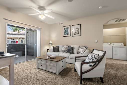 A living room with a couch, chair, and a table.