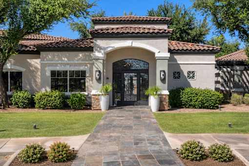 A house with a stone pathway leading to a black door.