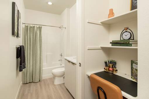 A bathroom with a toilet, sink, and shower.