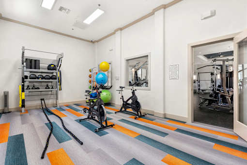 A gym with a variety of exercise equipment.