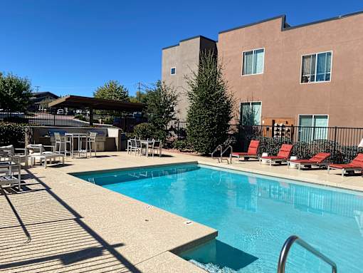 A swimming pool with a building in the background.
