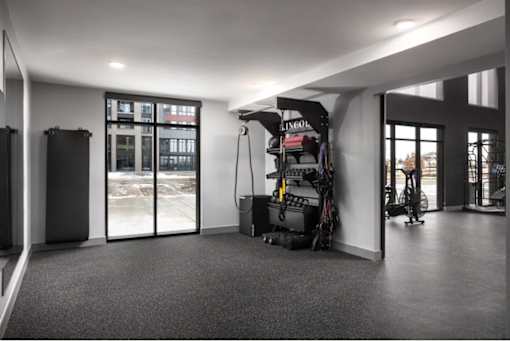 A room with a grey carpet and a black and white striped wall.