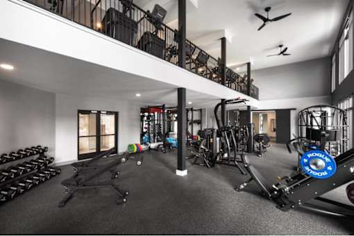 A spacious home gym with a variety of exercise equipment.