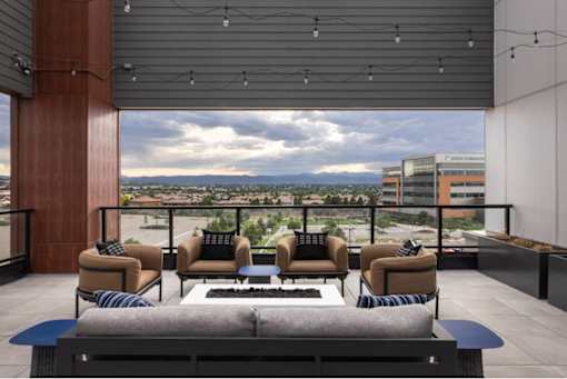 A modern outdoor seating area with a view of the cityscape.