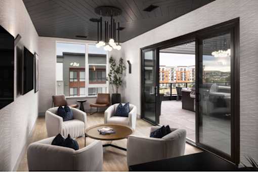 A modern living room with a glass door leading to a balcony.