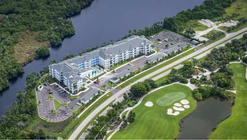 A golf course with a building in the background.