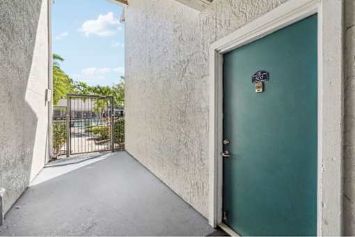 A green door with a number 307 on it is closed.