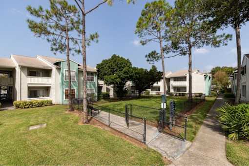 A residential area with houses and a fenced path.
