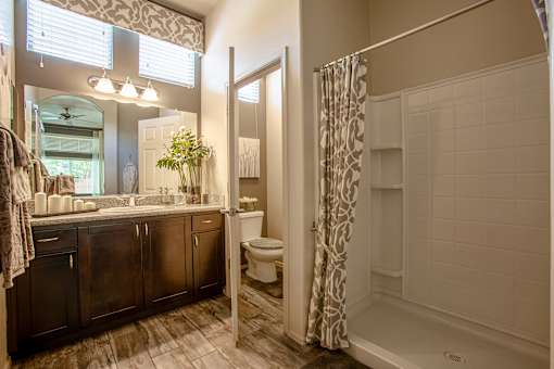 A bathroom with a white tub and a window.