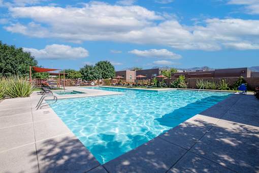 A swimming pool with a chair on the side.