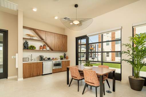 A modern kitchen with a dining table and chairs.
