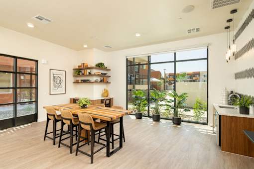 A modern dining room with a wooden table and chairs.