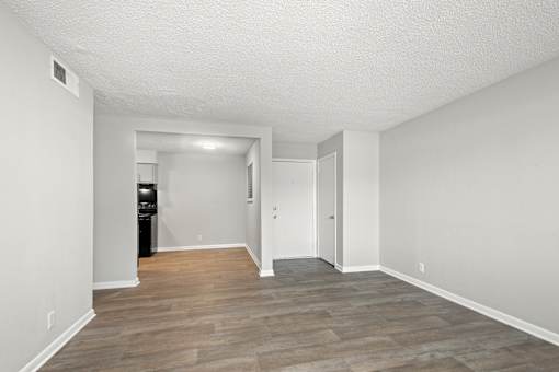 A room with a wooden floor and white walls.