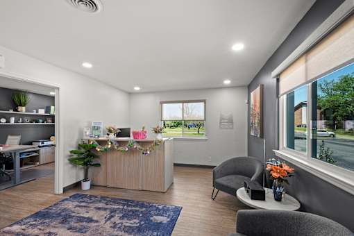 A reception area with a desk and chairs.