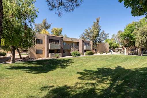 A building with a green lawn in front of it.