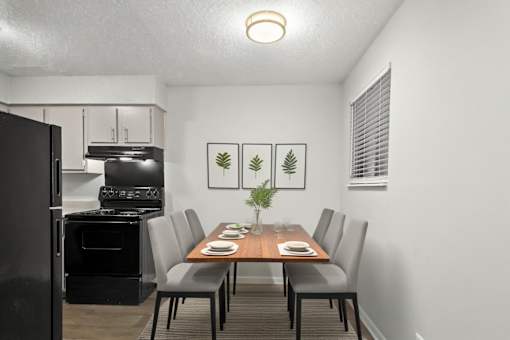 A black oven is in a kitchen next to a dining table.