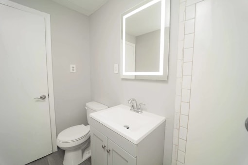 a bathroom with a sink toilet and a mirror  at Enclave West Hartford / Parc West, West Hartford, Connecticut