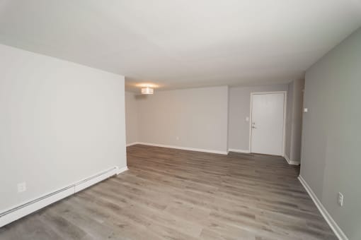 an empty living room with wood floors and white walls at Enclave West Hartford / Parc West, West Hartford, 06110