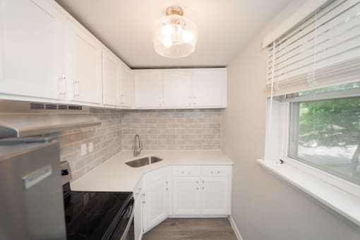 a small kitchen with white cabinets and a sink  at Enclave West Hartford / Parc West, West Hartford, CT, 06110