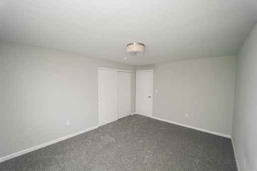 a bedroom with white walls and carpet and white doors  at Enclave West Hartford / Parc West, West Hartford