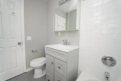 a white bathroom with a sink and a toilet at Encore 99, Connecticut, 06512