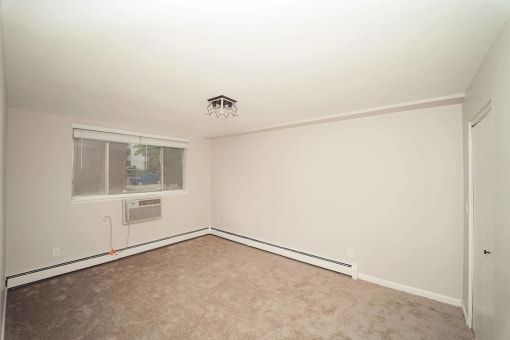 a empty room with a window and a ceiling fan at Five High, West Hartford, Connecticut