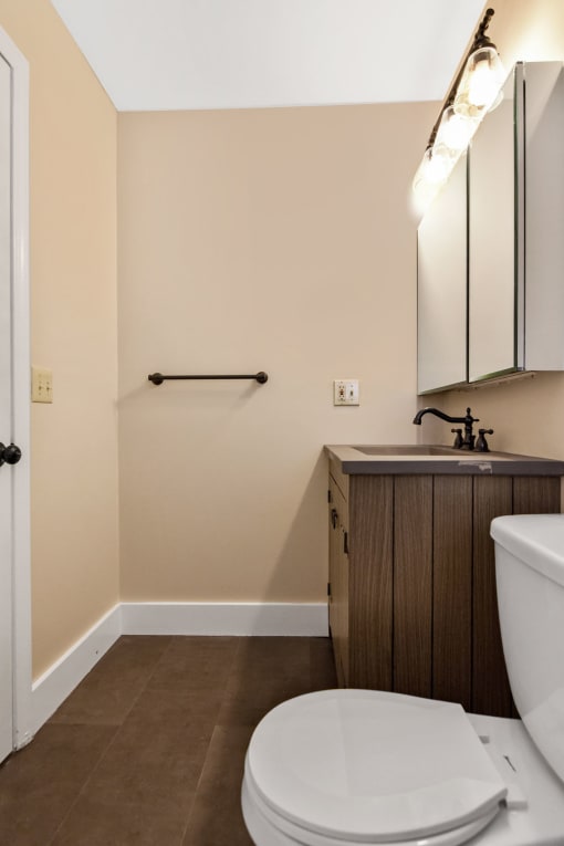 a small bathroom with a toilet and a sink at Retro 511 Apartments, West Haven, 06516