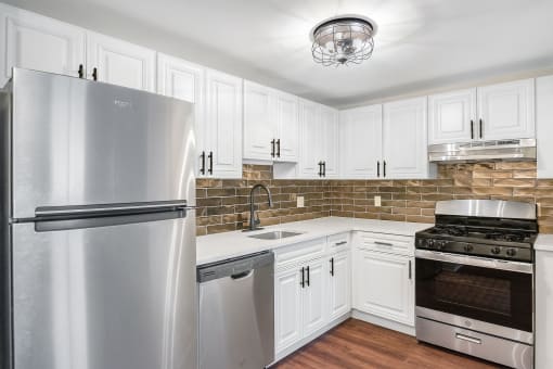 a kitchen with stainless steel appliances at Retro 511 Apartments, West Haven, CT