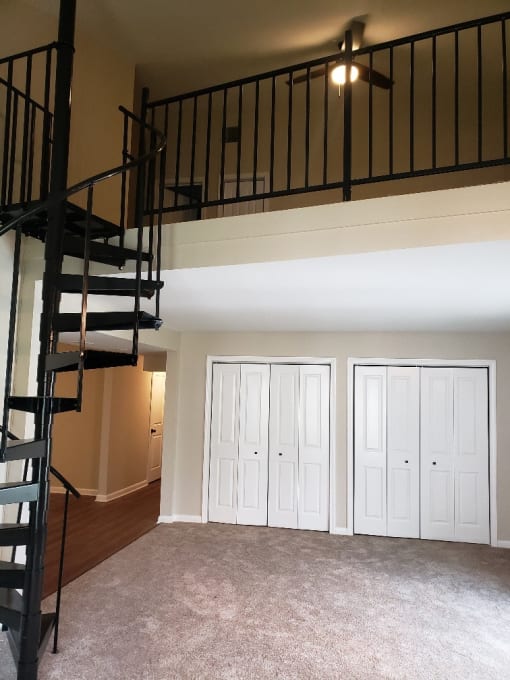 A black metal staircase with a fan on the ceiling at Retro 511 Apartments, West Haven, CT 06516