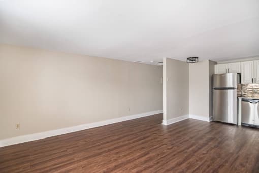 A kitchen area with a refrigerator, sink, and cabinets at Retro 511 Apartments, West Haven, CT