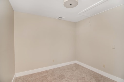 a empty room with beige walls and a ceiling fan at Retro 511 Apartments, Connecticut