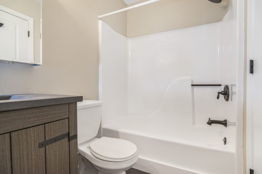 a bathroom with a toilet and a tub and a sink at Retro 511 Apartments, Connecticut