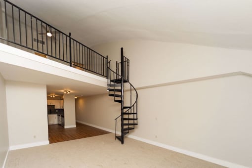 the loft of a home with a spiral staircase at Retro 511 Apartments, Connecticut 06516