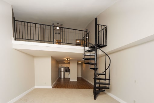 the loft in the great room of a house with a spiral staircase at Retro 511 Apartments, West Haven, 06516