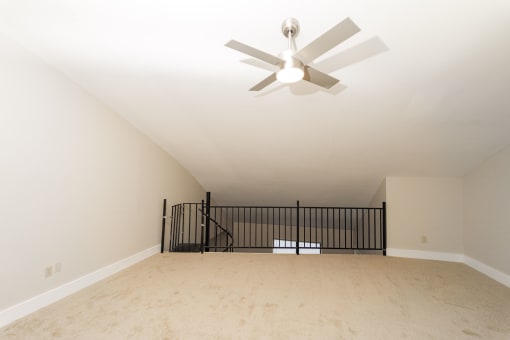 the spacious living room with a ceiling fan in a new home at Retro 511 Apartments, West Haven, Connecticut