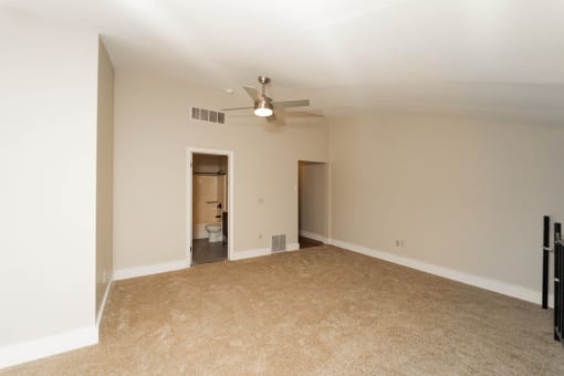an empty living room with a ceiling fan at Retro 511 Apartments, West Haven
