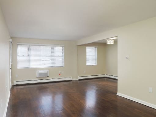 an empty living room with wood floors and a window at The Packard, West Hartford, Connecticut