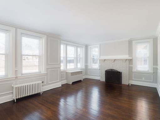 a living room with a fireplace and wooden floors at The Packard, West Hartford, CT, 06119