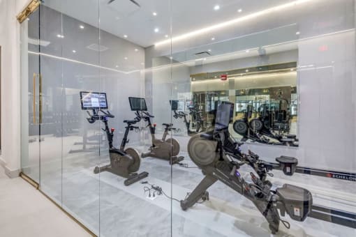 a gym with cardio equipment and glass walls at Up House, Connecticut