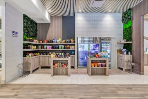 the lobby of a store with a refrigerator and shelves of food at Up House, Connecticut