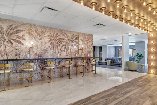 a lobby with a bar with chairs and a wall mural of palm trees at Up House, Farmington, CT, 06032