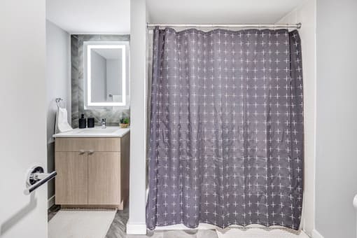 a bathroom with a shower curtain and a sink at Up House, Farmington, Connecticut