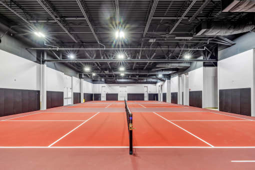 a tennis court in a building with lights on the ceiling at Up House, Farmington, Connecticut