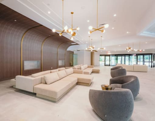 a lobby with couches and chairs and chandeliers at Up House, Farmington, CT, 06032