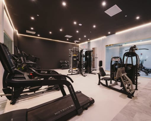 a gym with treadmills and other exercise equipment on a white floor at Up House, Farmington, Connecticut