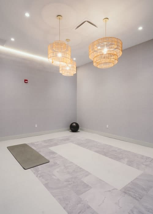 an empty room with two chandeliers and a rug at Up House, Farmington, Connecticut
