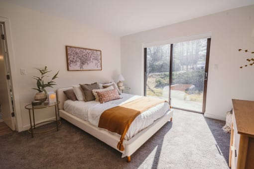 a bedroom with a bed and a sliding glass door at Up House, Farmington